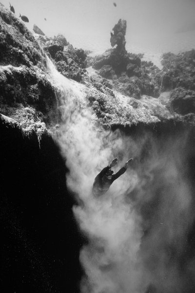 Freediver Herbert Nitsch flying out of a sand avalanche